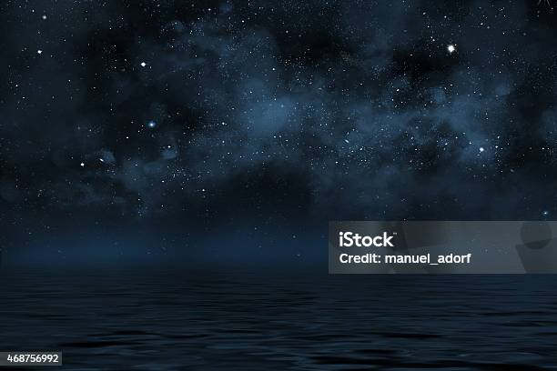 Night Sky With Stars And Blue Nebula Over Water Stock Photo - Download Image Now - Night, Sea, Sky