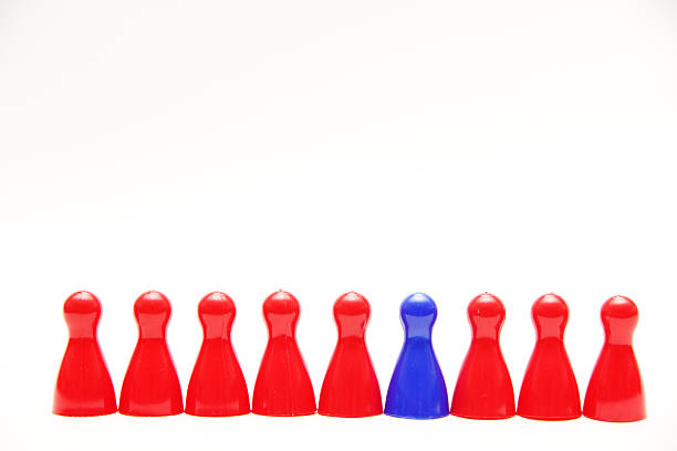 istock Odd one out blue counter amongst reds 468759272