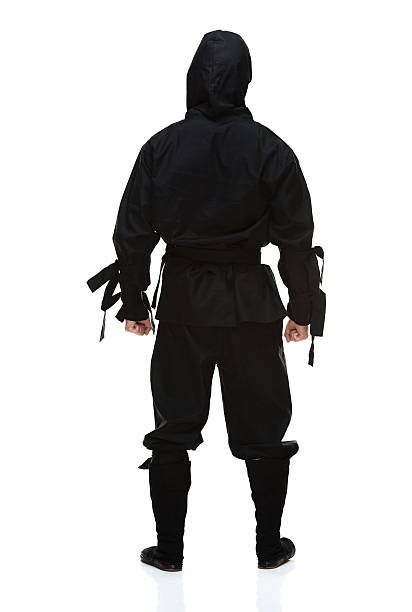 Rear View Of Ninja Standing And Looking Away Stock Photo
