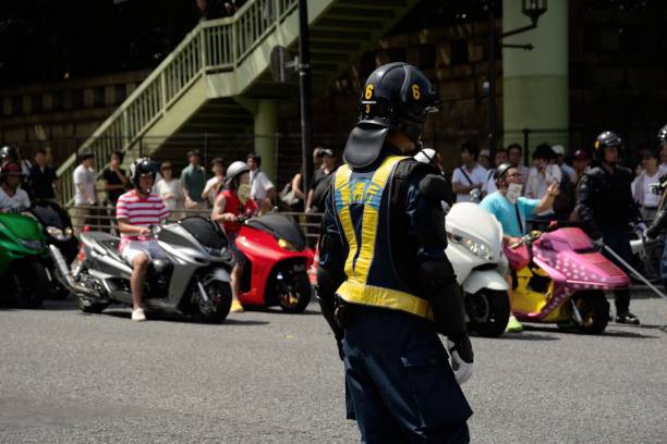 End of The War Day Tokyo, Japan  - August 15, 2014: A policeman trying to regulate traffic during the End of the War Day, in front of the notorious Yasukuni Shrine. vj day stock pictures, royalty-free photos & images