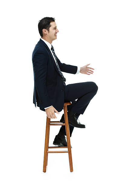 istock Smiling businessman on stool and looking away 468780604