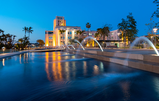 Photo of Fountains at Waterfront Park in Downtown San Diego with the San Diego County Administration Center in the Background at Twilight.