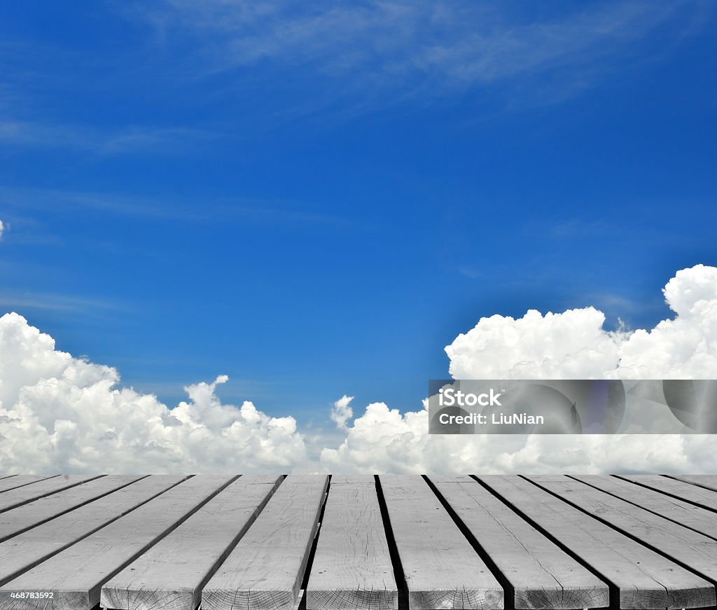 Empty wooden platform with summer cloudy sky background Empty wooden platform with summer cloudy sky background  2015 Stock Photo