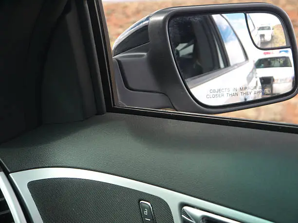 Photo of Police car in rear view mirror
