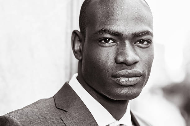 istock Handsome black man wearing suit in urban background 468786382