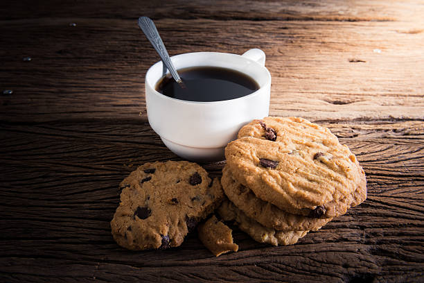 istock Coffee cup with chocolate cookie on dark wooden 468786780