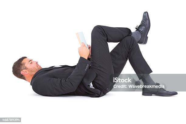 Businessman Lying On The Floor Reading Book Stock Photo - Download Image Now - Businessman, Flooring, Reading