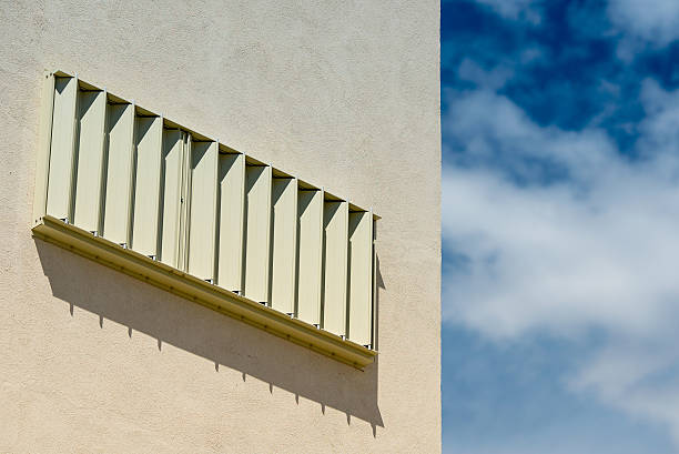 istock Hurrican window protection on white concrete home 468789452