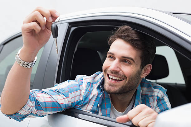 istock Young man smiling and showing key 468791938