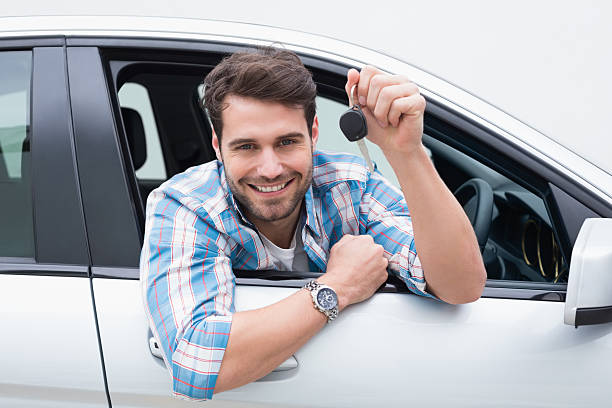 istock Young man smiling and showing key 468791942