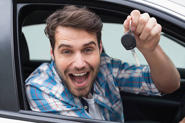 istock Young man smiling and holding key 468791946