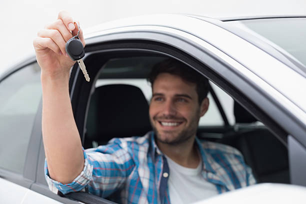 istock Young man smiling and holding key 468791990