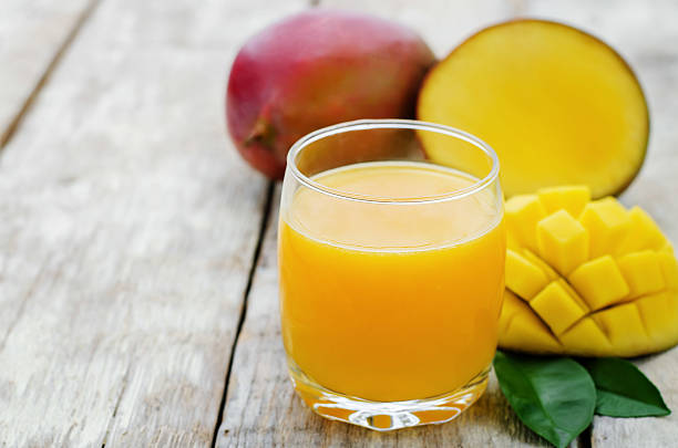 istock Mango juice made fresh and a freshly cut up mango 468792218