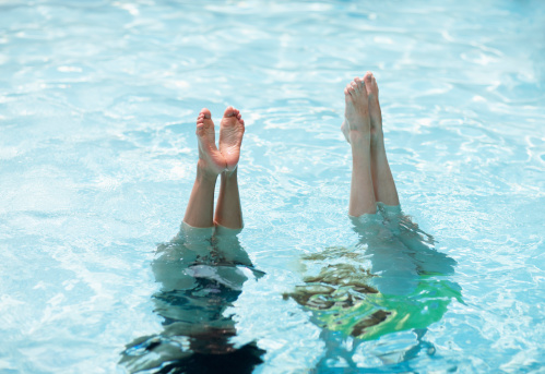 Two Women Doing Handstand in Pool