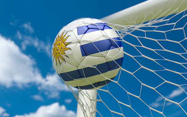 istock Uruguay flag and soccer ball in goal net 468794193