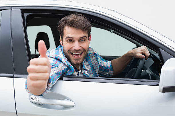 istock Young man smiling and showing thumbs up 468794538