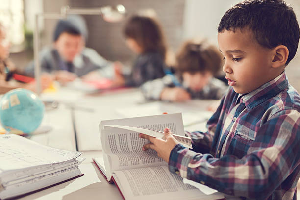 istock African American little boy reading a book. 468794756