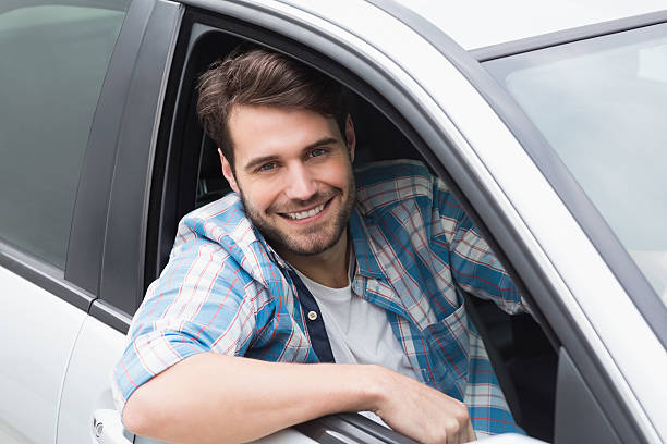istock Young man driving and smiling 468794920