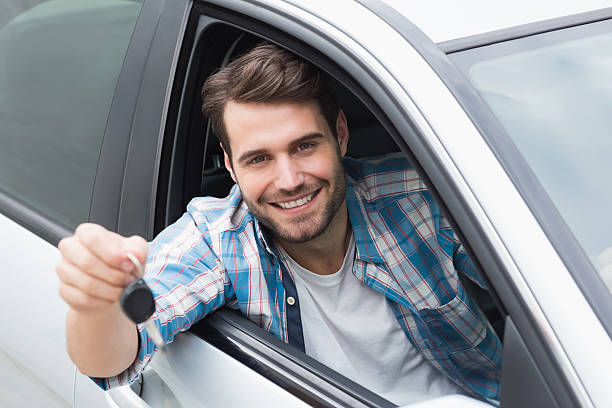 istock Young man smiling and holding key 468794930