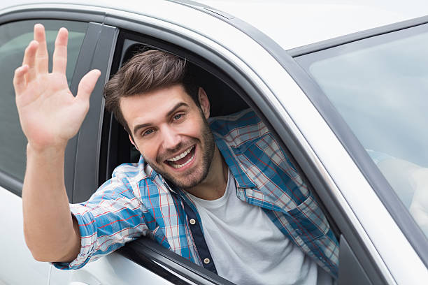 istock Young man smiling and waving 468794960