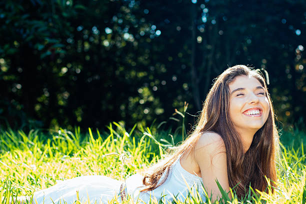 istock Happy girl lying in the grass 468796578