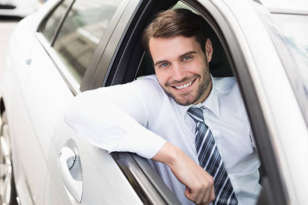 istock Happy businessman sitting in drivers seat 468796698