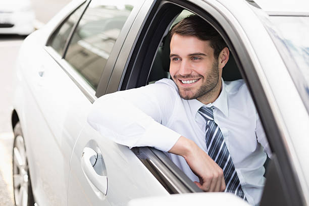 istock Happy businessman sitting in drivers seat 468796700