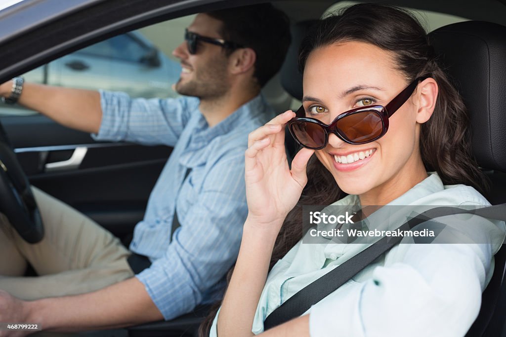Young couple on a road trip Young couple on a road trip in their car Car Stock Photo