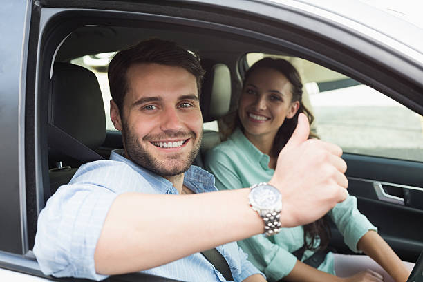 istock A young couple smiling inside their car 468799286