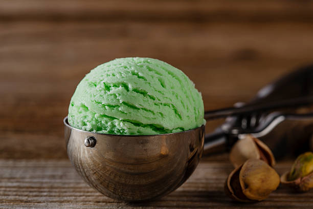 istock pistachio ice cream ball in a spoon scoop 468799340
