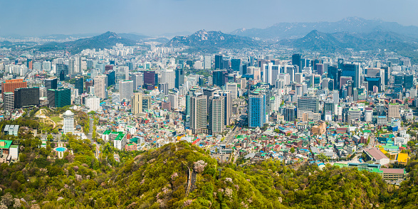 Aerial panoramic vista across the skyscrapers and landmarks, mountain parks and crowded downtown district of central Seoul, South Korea. ProPhoto RGB profile for maximum color fidelity and gamut.