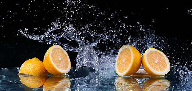 istock Sliced lemon in the water on black background 468799522