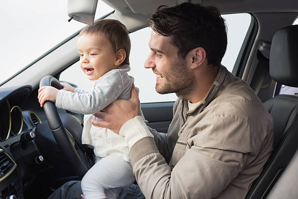 istock Father playing with baby in drivers seat 468799568
