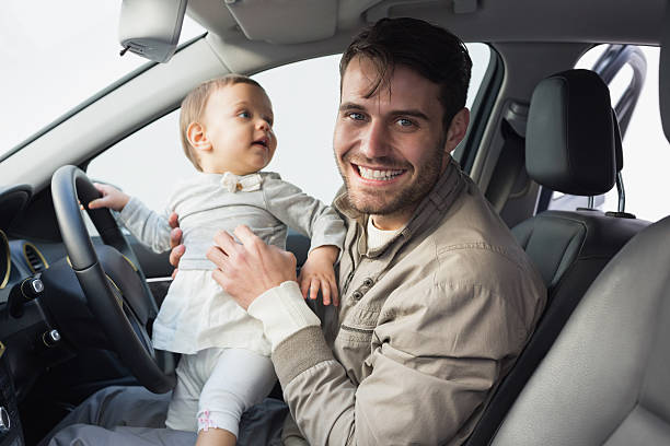 istock Father playing with baby in drivers seat 468799574