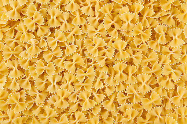 italian pasta farfalle senza cuciture fantasia " - italian cuisine dry pasta directly above foto e immagini stock