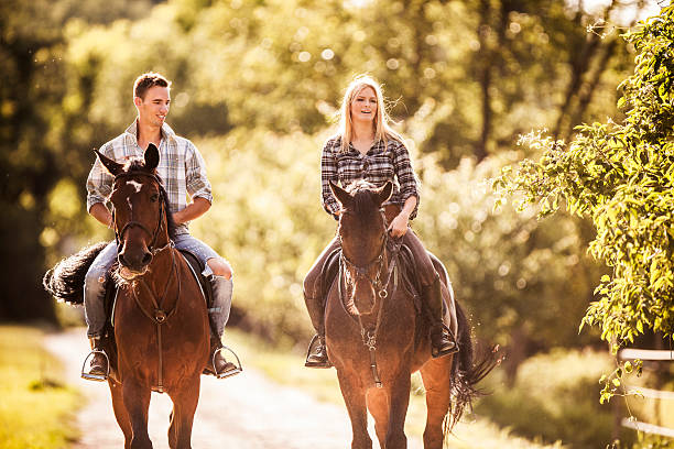 istock Young couple horseback riding in nature. 468802106