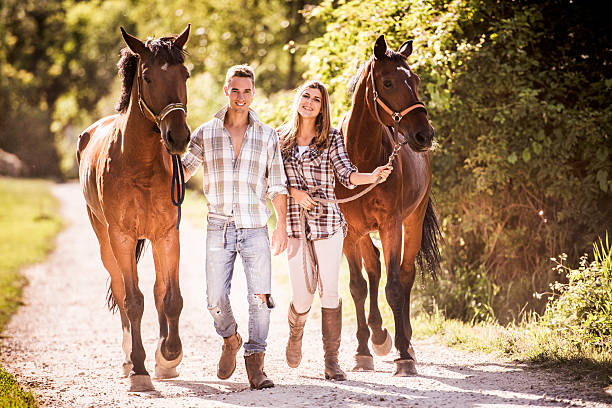 istock Happy couple walking with horses in nature. 468802168