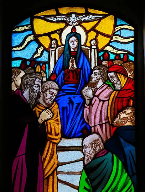Stained glass window depicting the Descent of the Holy Spirit at Pentecost in the Church of Ostuni, Apulia, Italy. This window is more than 100 years old, no property release is required.