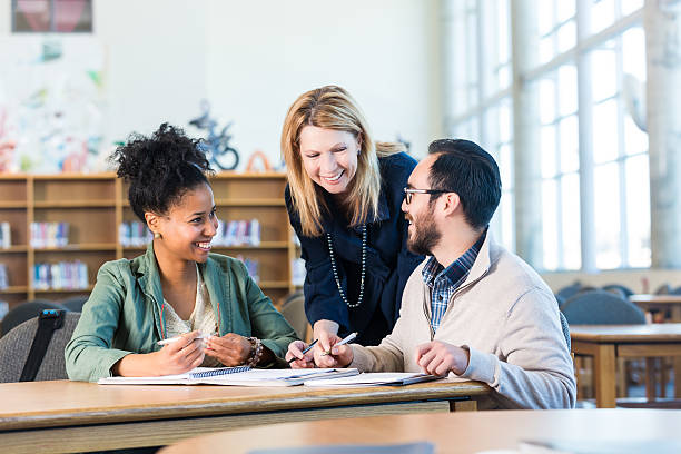 istock Study group, two multi-ethinic adult college students with tutor 468807402