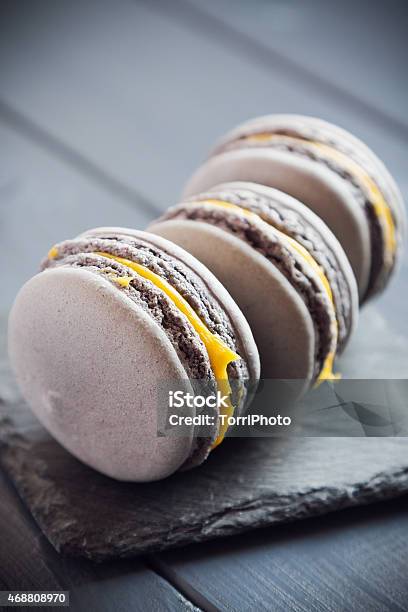 Gray Macaroons On Dark Grey Background Stock Photo - Download Image Now - 2015, Back Lit, Baked