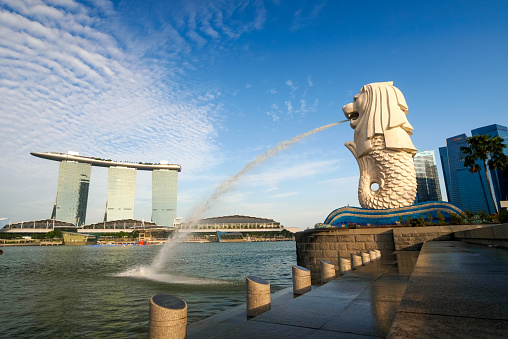 Singapore City, Singapore - June 20, 2014: View of Merlion Statue at Marina Bay in Singapore with tourists and Singapore Skyline in background.