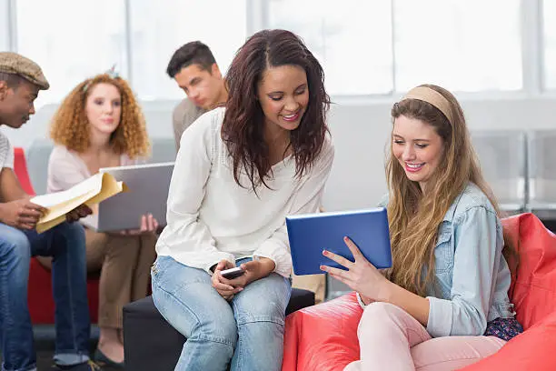 Photo of Fashion students using tablet together