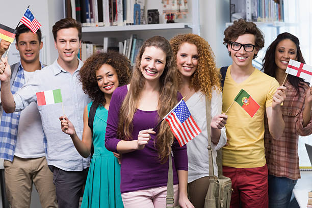 istock Happy students waving international flags 468813576