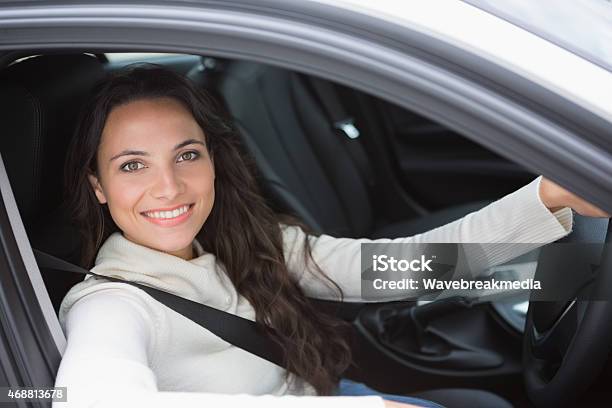 Pretty Woman Smiling And Driving Stock Photo - Download Image Now - 20-24 Years, 20-29 Years, 2015