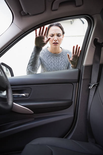 istock Sad woman looking inside the car 468813884