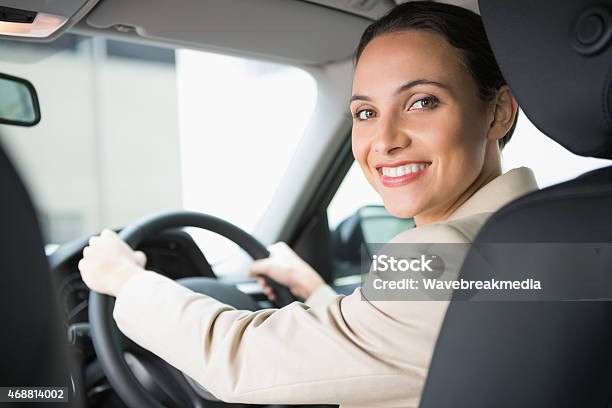 Pretty Businesswoman Smiling And Driving Stock Photo - Download Image Now - 20-24 Years, 20-29 Years, 2015
