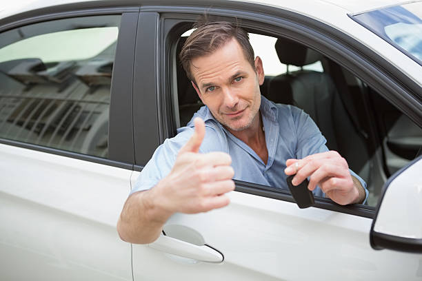 istock Smiling man giving thumbs up and holding key 468814086