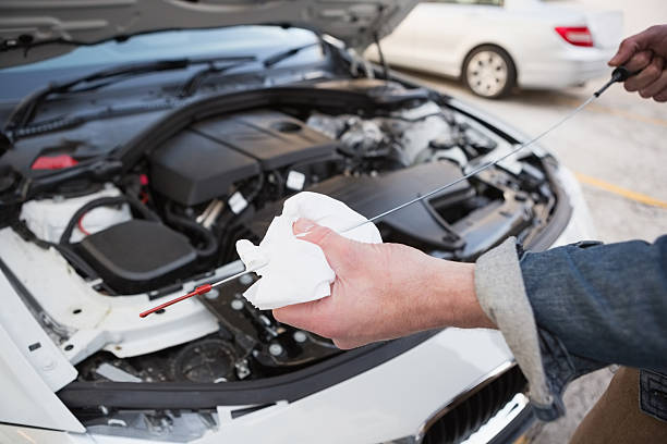 ている男性のクローズアップのチェックエンジンオイル車 - vehicle breakdown hood car oil change ストックフォトと画像