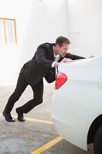 istock Businessman pushing his broken down car 468816648