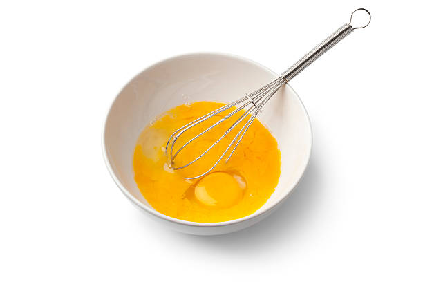 istock Beaten egg yolks in a bowl with whisk 468817706
